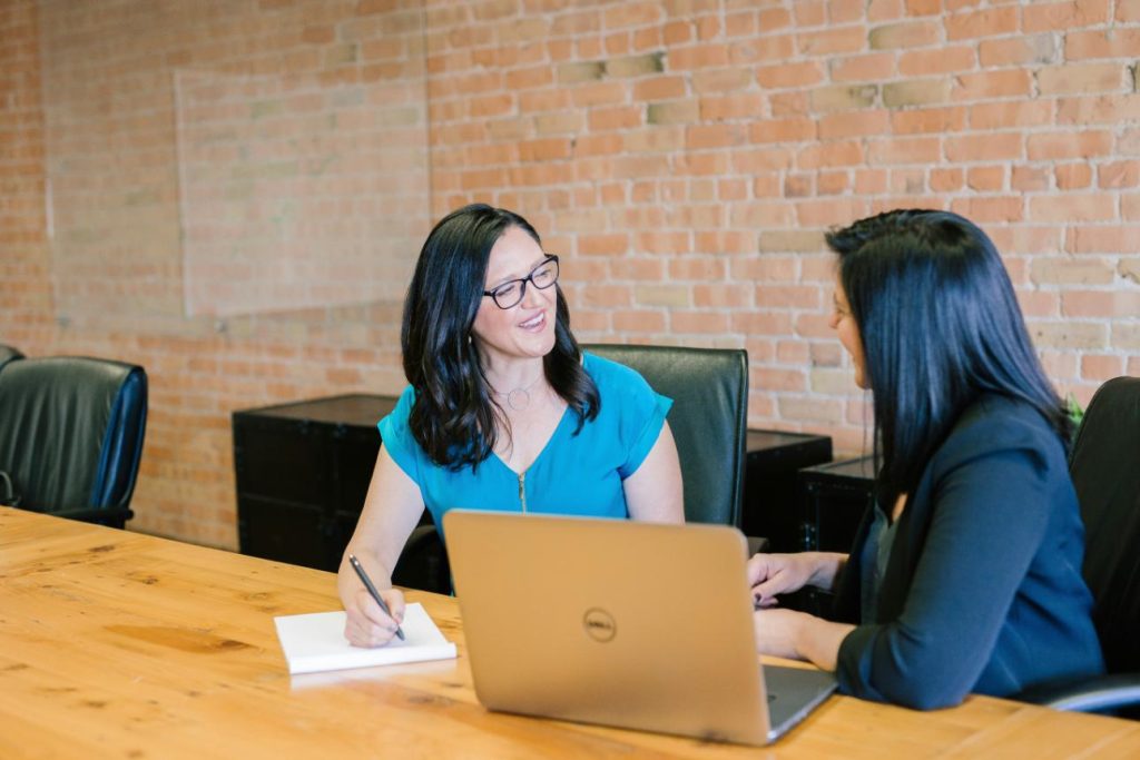 Two women discussing in office