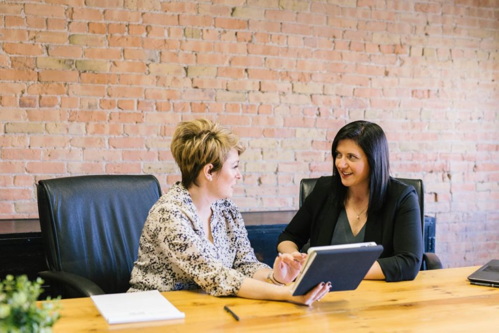 Two women discussing at table