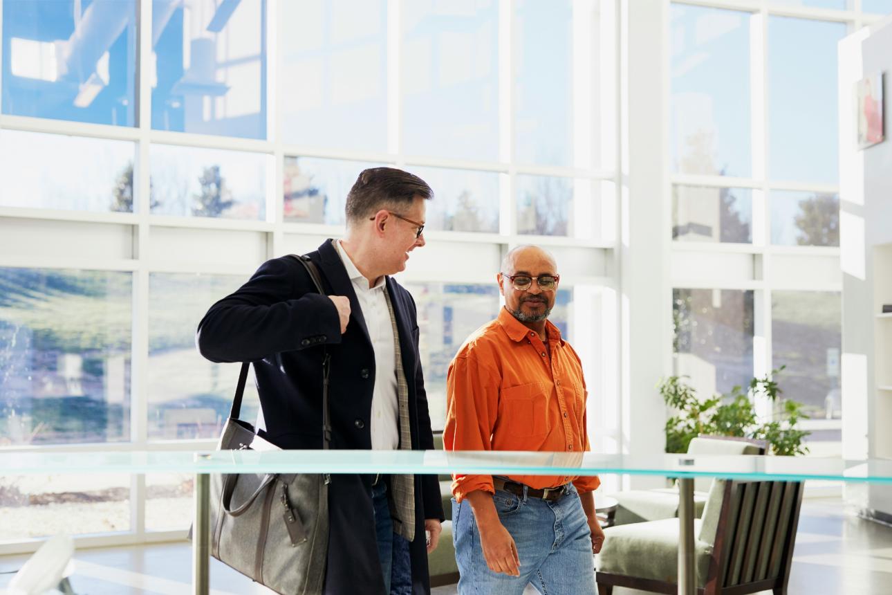 Two men talking indoors