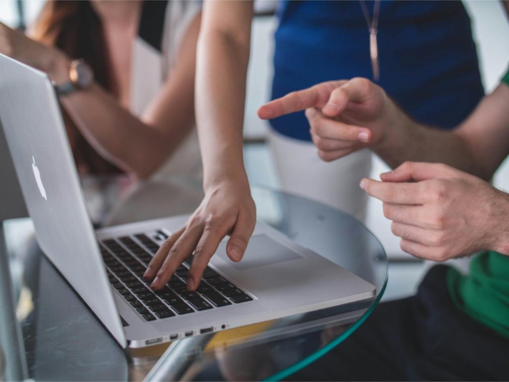 Hands using a laptop together